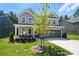 Beautiful two-story home featuring stone accents, a two-car garage, and professionally landscaped front yard at 2024 Cedar Falls Dr # 9, Waxhaw, NC 28173