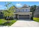 Charming two-story house boasting a gray exterior, well-manicured lawn, and a spacious two-car garage at 2024 Cedar Falls Dr # 9, Waxhaw, NC 28173