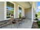 Cozy front porch showcasing stylish chairs, decorative plants, and neutral-toned exterior at 2024 Cedar Falls Dr # 9, Waxhaw, NC 28173