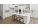 Bright kitchen showcasing a large island with seating, white cabinetry, and stainless steel appliances at 2024 Cedar Falls Dr # 9, Waxhaw, NC 28173