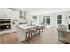 Open-concept kitchen with white cabinets, stainless steel appliances, and a large center island at 2024 Cedar Falls Dr # 9, Waxhaw, NC 28173