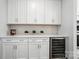 A well-appointed kitchen features white cabinets and stainless steel wine cooler at 2024 Cedar Falls Dr # 9, Waxhaw, NC 28173