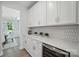 Stylish kitchen with white cabinetry, wine cooler, elegant backsplash, and ample counter space at 2024 Cedar Falls Dr # 9, Waxhaw, NC 28173