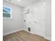 Bright Laundry Room with wood-look tile floor, white walls, and wire shelving at 2024 Cedar Falls Dr # 9, Waxhaw, NC 28173