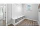 White mudroom includes bench with storage and hooks for an organized entryway space at 2024 Cedar Falls Dr # 9, Waxhaw, NC 28173