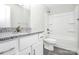 Bathroom vanity featuring white cabinets, gray countertops, with a white toilet and bathtub at 6187 Long Branch Rd, Salisbury, NC 28147