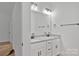 Bathroom featuring a double vanity with granite countertop and modern fixtures at 6187 Long Branch Rd, Salisbury, NC 28147