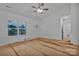 Sunlit bedroom with a large window, white walls, and a ceiling fan, awaiting personal touches to create a cozy space at 6187 Long Branch Rd, Salisbury, NC 28147