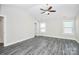 Spacious bedroom features modern ceiling fan and grey wood-look flooring and natural light at 6187 Long Branch Rd, Salisbury, NC 28147