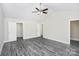 Spacious bedroom features modern ceiling fan and grey wood-look flooring at 6187 Long Branch Rd, Salisbury, NC 28147