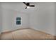 Bright bedroom features sleek ceiling fan, hardwood floors, and natural light at 6187 Long Branch Rd, Salisbury, NC 28147