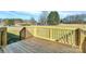 Wooden deck boasts a scenic view of mature trees and a green yard at 6187 Long Branch Rd, Salisbury, NC 28147