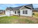 Exterior view showing a garage and white siding, enhanced by well-maintained landscaping, blending curb appeal and functionality at 6187 Long Branch Rd, Salisbury, NC 28147