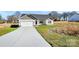 Home showcasing light colored siding, a garage, and long driveway, offering a blend of style and convenience at 6187 Long Branch Rd, Salisbury, NC 28147