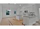 Modern kitchen featuring white cabinets, a granite countertop, stainless steel appliances, and an island with bar seating at 6187 Long Branch Rd, Salisbury, NC 28147