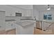 Modern kitchen with white cabinetry, stainless steel appliances, a granite countertop, and functional island seating at 6187 Long Branch Rd, Salisbury, NC 28147