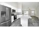 This kitchen features white cabinets, stainless steel appliances, an island, and gray countertops at 6187 Long Branch Rd, Salisbury, NC 28147