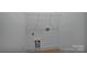 Bright laundry room with white walls, washer/dryer hookups and wire shelving at 6187 Long Branch Rd, Salisbury, NC 28147