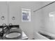 Modern bathroom features dual sinks with black fixtures and a shower-tub combo with natural light at 6201 Long Branch Rd, Salisbury, NC 28147