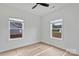 Bright bedroom with two windows, a ceiling fan, and neutral walls creating a cozy, inviting atmosphere at 6201 Long Branch Rd, Salisbury, NC 28147