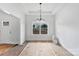 Inviting dining area with modern chandelier and large window, offering serene views of the outdoors and ample natural light at 6201 Long Branch Rd, Salisbury, NC 28147