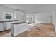 Modern kitchen features a central island, granite counters, white cabinets, and stainless sink to create a chefs haven at 6201 Long Branch Rd, Salisbury, NC 28147