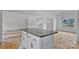 Open-concept kitchen area featuring a central island with stone counter, sleek cabinets, and an inviting, connected living space at 6201 Long Branch Rd, Salisbury, NC 28147