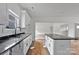 Bright kitchen with granite counters, white cabinets, island, and a view into the next room making it great for entertaining at 6201 Long Branch Rd, Salisbury, NC 28147