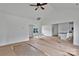 Bright, open living room featuring high ceilings, ceiling fan, and seamless transition to the kitchen and dining areas at 6201 Long Branch Rd, Salisbury, NC 28147