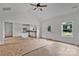 Bright, open living room with vaulted ceilings, fan, with seamless transition to the kitchen, door and window views at 6201 Long Branch Rd, Salisbury, NC 28147