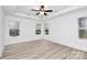 Bright main bedroom with multiple windows and light wood flooring at 6201 Long Branch Rd, Salisbury, NC 28147