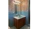 Retro bathroom features a blue tile and a wood vanity with a matching sink and mirror at 2310 Montford Nw Ave, Concord, NC 28027