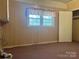 Bedroom with cozy carpet, light-filled windows, and a closet for storage at 2310 Montford Nw Ave, Concord, NC 28027