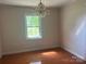 Bedroom featuring hardwood floors, natural lighting and a decorative chandelier light fixture at 2310 Montford Nw Ave, Concord, NC 28027
