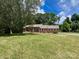 Charming brick home with a well-manicured lawn and inviting front porch, perfect for relaxing outdoors at 2310 Montford Nw Ave, Concord, NC 28027