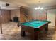Spacious game room with a pool table, brick fireplace, and vintage paneled walls at 2310 Montford Nw Ave, Concord, NC 28027