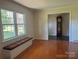 Bright living room featuring hardwood floors, a window bench, and an open doorway to the foyer at 2310 Montford Nw Ave, Concord, NC 28027