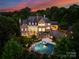 Luxury estate with pool and expansive grounds at sunset at 4536 Fox Brook Ln, Charlotte, NC 28211