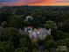 Luxury home nestled in a wooded area with a pool at 4536 Fox Brook Ln, Charlotte, NC 28211