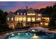 Luxury home with pool and beautiful landscaping at dusk at 4536 Fox Brook Ln, Charlotte, NC 28211