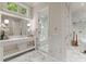 Spa-like bathroom with marble tile, a large shower, and a spacious vanity at 4536 Fox Brook Ln, Charlotte, NC 28211