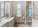 Spa-like bathroom with marble finishes, a large shower, and a window at 4536 Fox Brook Ln, Charlotte, NC 28211