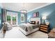 Light and airy bedroom with a calming blue wall and french doors at 4536 Fox Brook Ln, Charlotte, NC 28211
