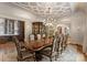 Elegant dining room featuring a large table, chandelier, and wine storage at 4536 Fox Brook Ln, Charlotte, NC 28211