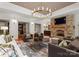 Spacious Gathering room features a stone fireplace, comfortable seating, and a large TV at 4536 Fox Brook Ln, Charlotte, NC 28211