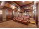 Opulent home theater with reclining leather seats and a large projection screen at 4536 Fox Brook Ln, Charlotte, NC 28211