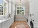Laundry room with ample counter space, storage, and a terracotta floor at 4536 Fox Brook Ln, Charlotte, NC 28211