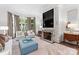 Spacious living room with a large TV, fireplace, and comfortable seating at 4536 Fox Brook Ln, Charlotte, NC 28211