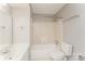 A clean bathroom features white tile, a single sink vanity, and a standard toilet and shower/tub combo at 1600 Sharon W Rd # 11, Charlotte, NC 28210