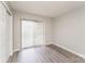 This light and airy bedroom features sliding glass doors to the outside and gray wood floors at 1600 Sharon W Rd # 11, Charlotte, NC 28210
